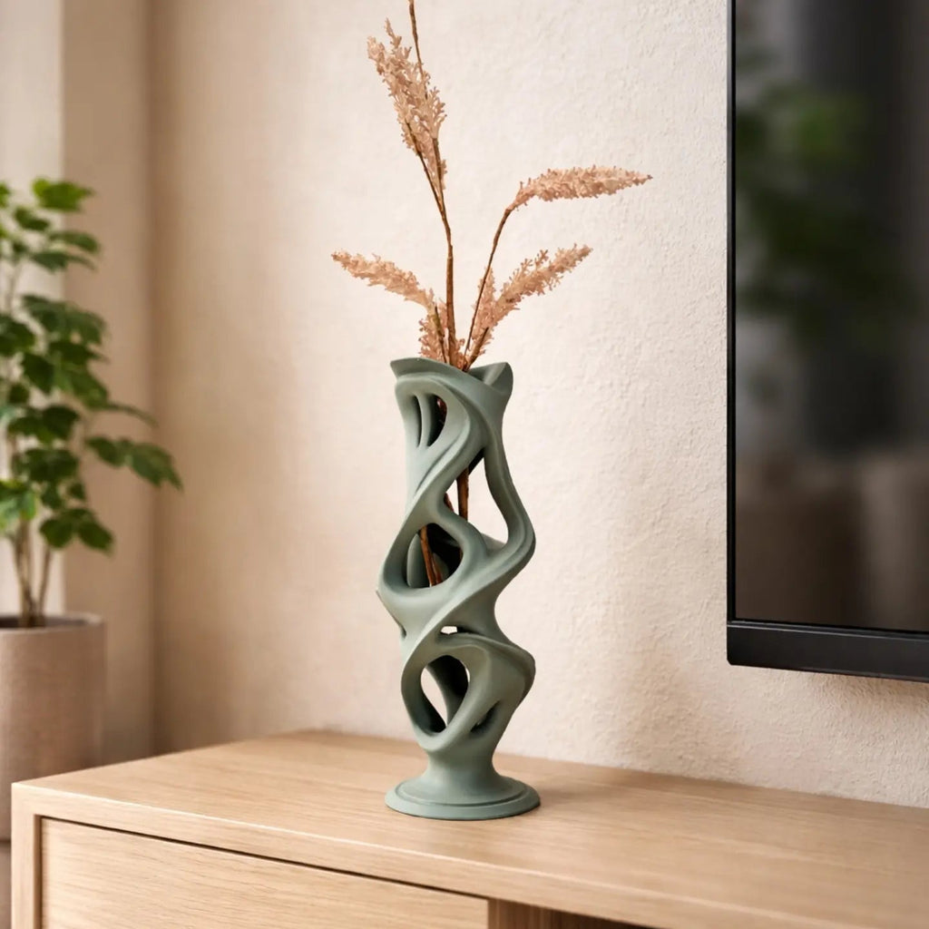Decorative vase with dried plants on a wooden surface, with a blurred background